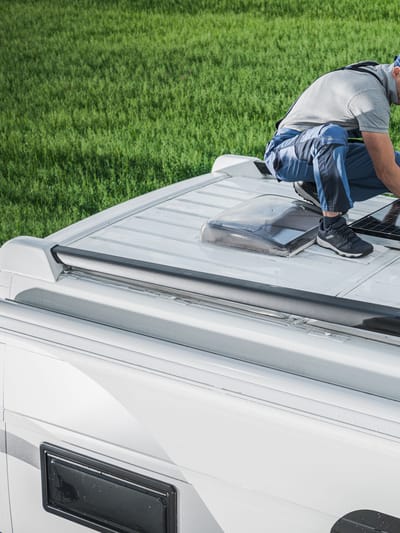 man doing RV solar setup on the roof of his motorhome